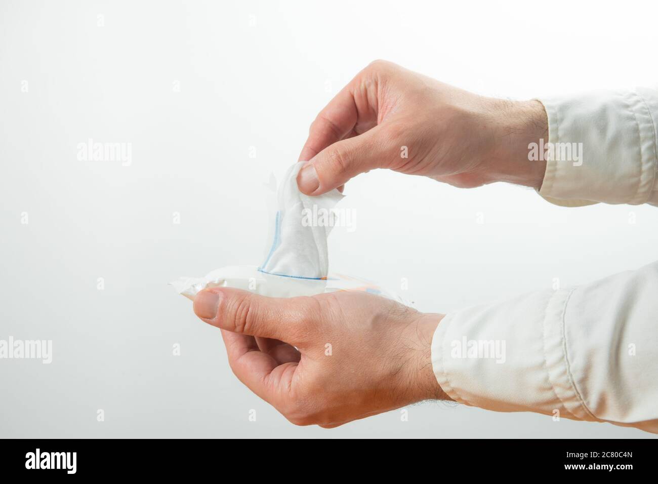 Man hand picked a wet wipes in package box. Stock Photo