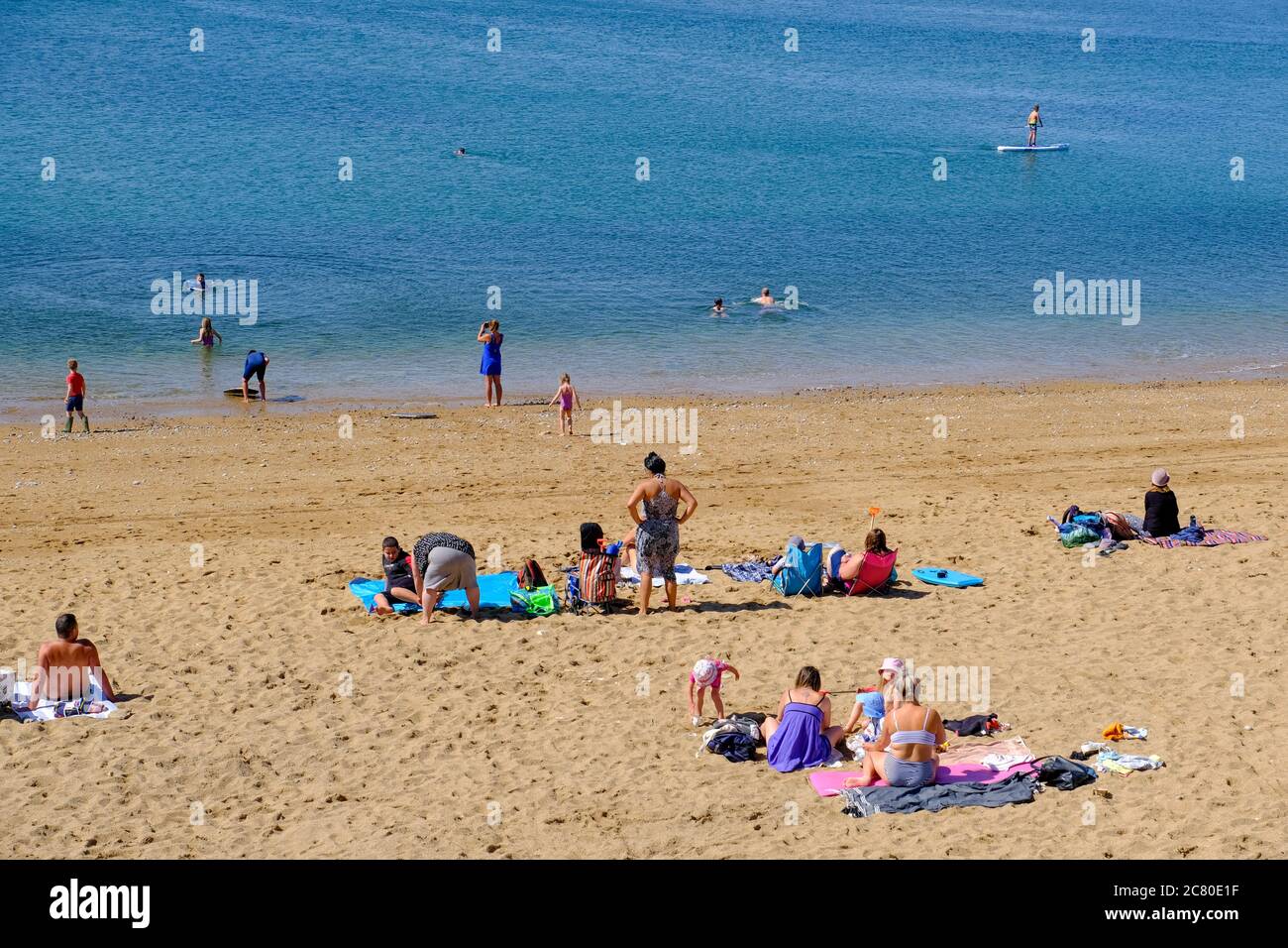 West Bay, Dorset, UK. 20th July, 2020. Holiday makers return to West Dorset as hospitality industry begins to open up and the the sunny weather continues. Credit: Tom Corban/Alamy Live News Stock Photo