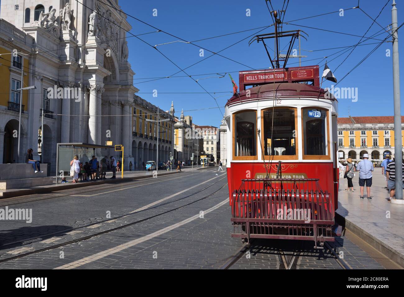 LISBON, PORTUGAL – June 11, 2017: Vintage red tram shown on the square Praca de Comercio (Commerce square), Rua Augusta triumphal arch on background Stock Photo