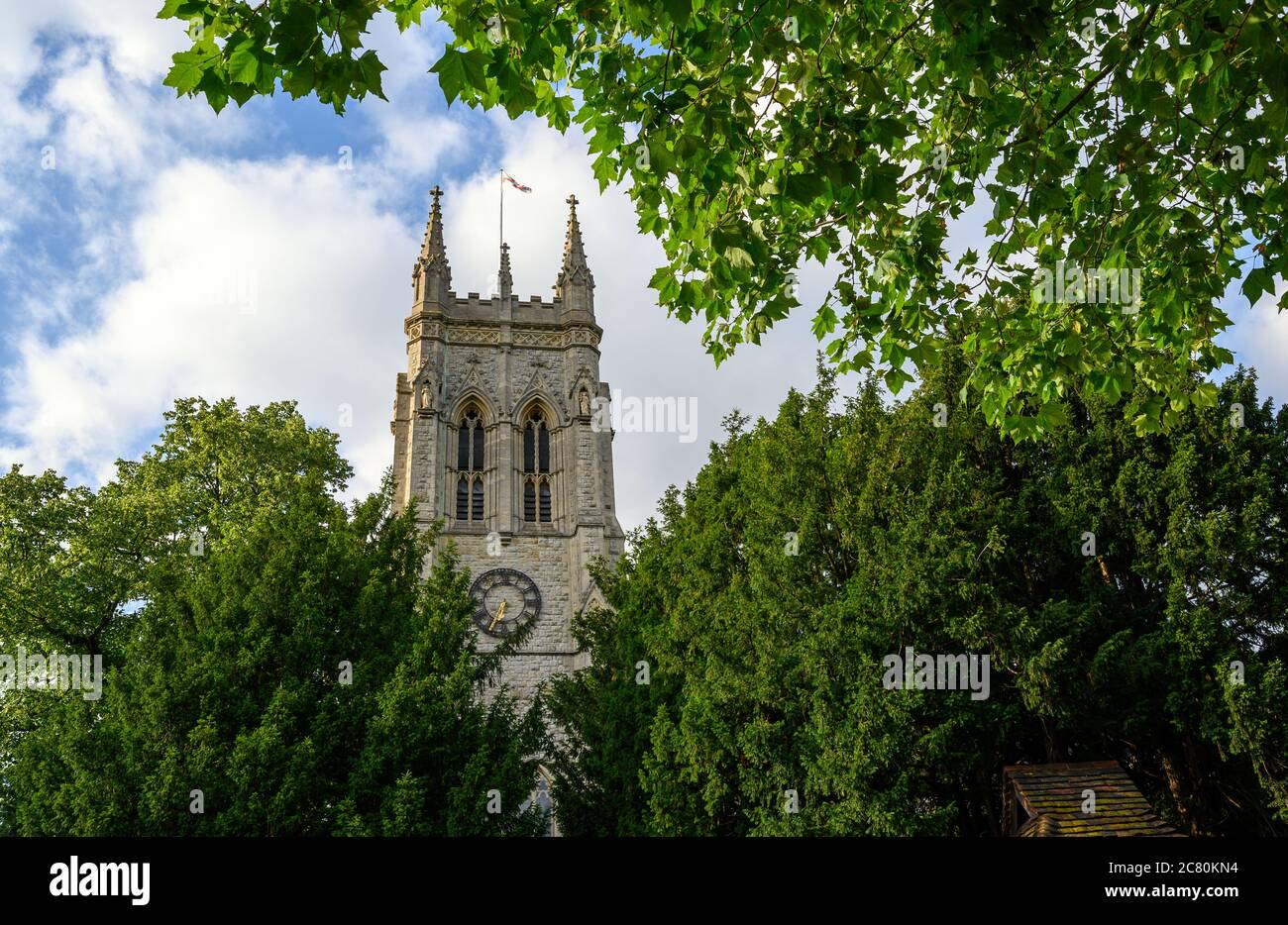 Beckenham (Greater London), Kent, UK. St George's Church in Beckenham with a square tower framed by trees. A Church of England parish church. Stock Photo
