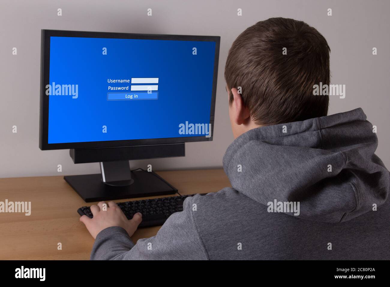 young man typing username and password in personal computer Stock Photo