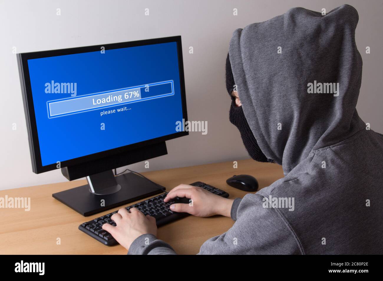male thief in mask stealing data from computer Stock Photo - Alamy