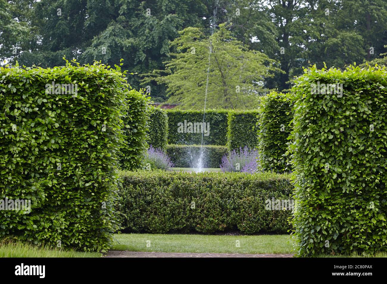 View of the Central Fountain and beech hedges at Scampston Hall walled garden designed by the dutch landscape garden architect Piet Oudolf Stock Photo