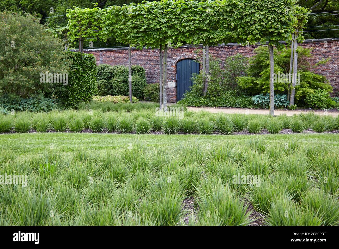 View of the Drifts of Grass Garden within the Walled Garden of the stately Regency home Scampston Hall in North Yorkshire Stock Photo