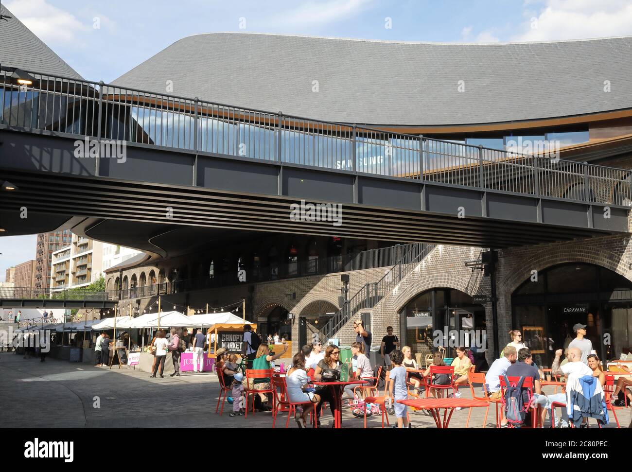 Outdoor seating in the summer sunshine in post corona times at CDY, at Kings Cross, London, UK Stock Photo