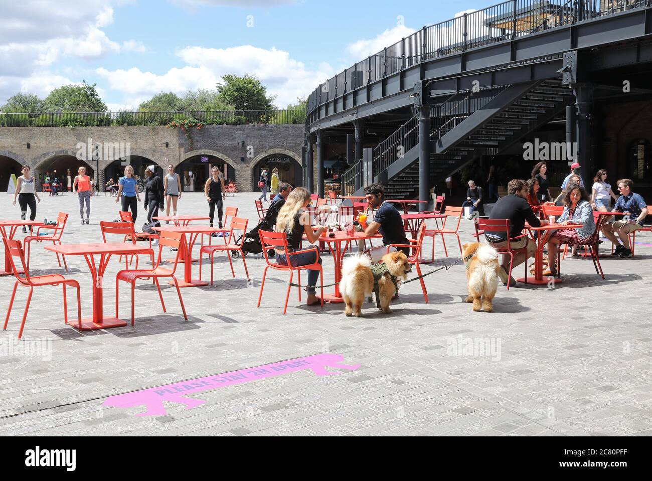 Outdoor seating in the summer sunshine in post corona times at CDY, at Kings Cross, London, UK Stock Photo