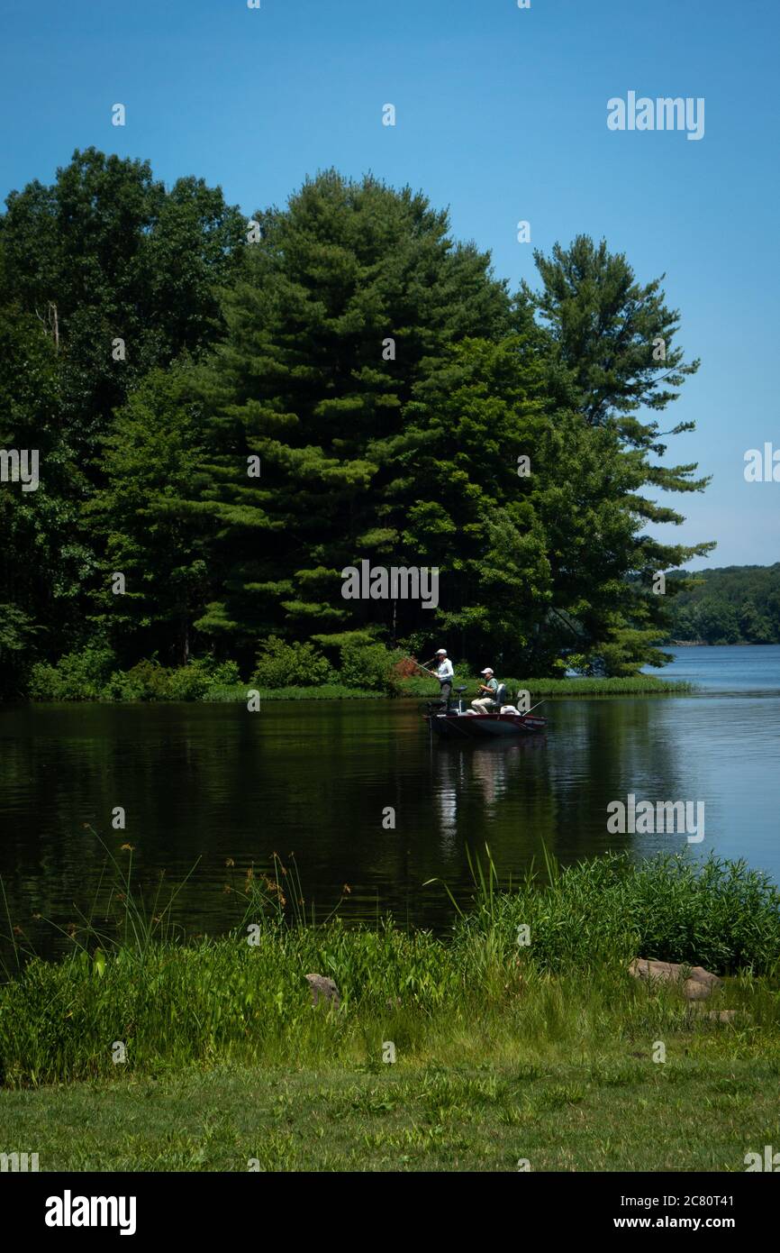 Two men fishing in a fishing boat on Lake Wilhelm, Maurice K. Goddard