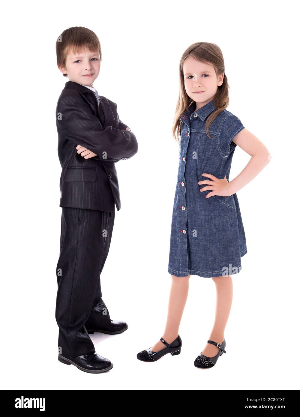little boy in business suit and girl in dress isolated on white