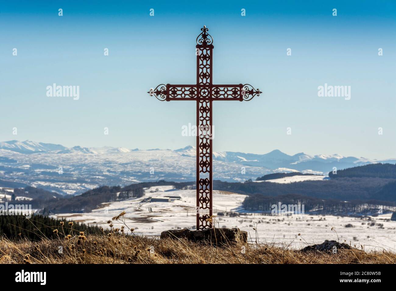 Cross and view on Cantal mountains, Auvergne, France Stock Photo