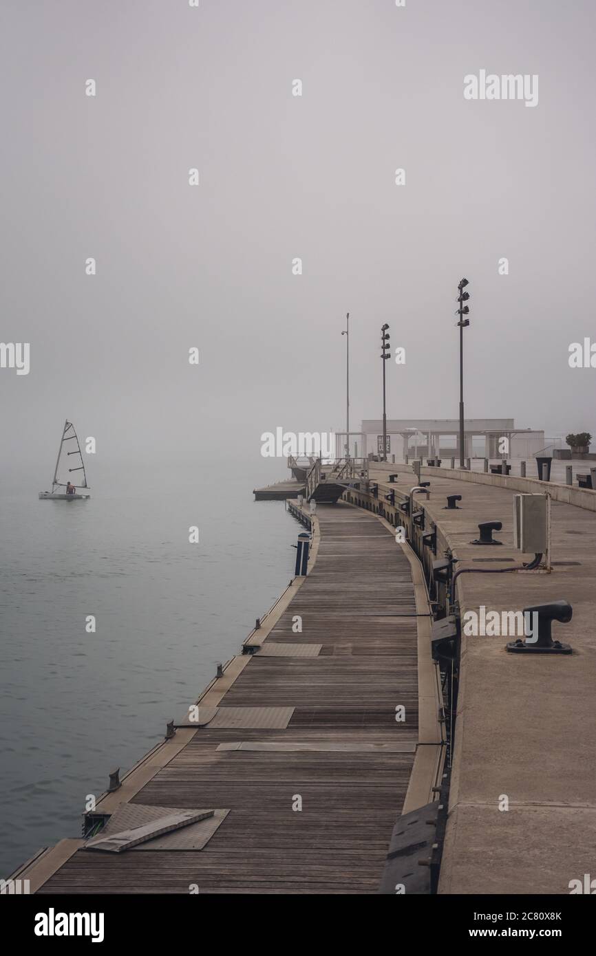 Vertical shot of a city shore and deck on a gloomy foggy day Stock ...