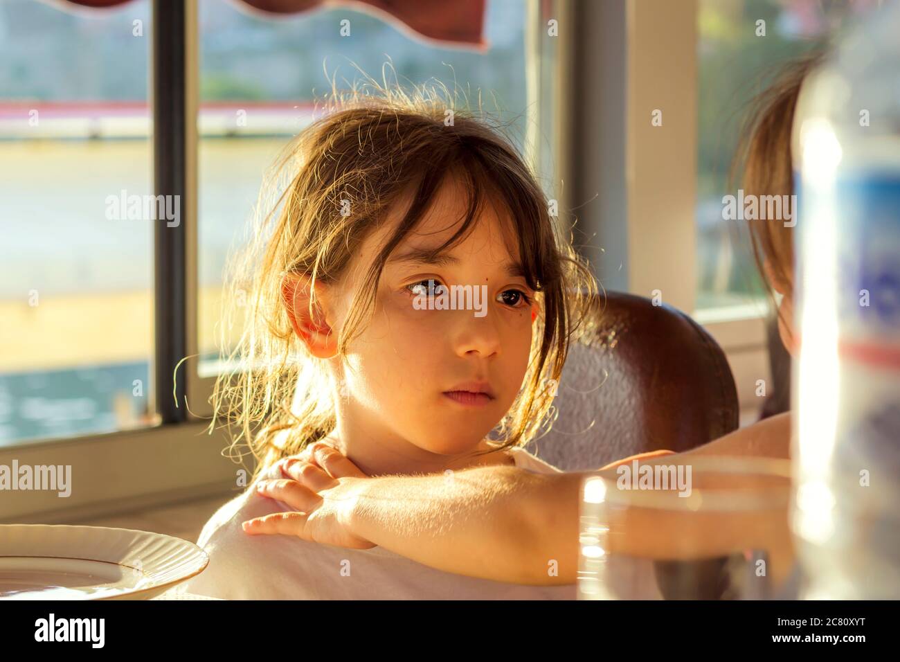 unhappy and tired girl. the little girl is exposed to peer bullying. Stock Photo
