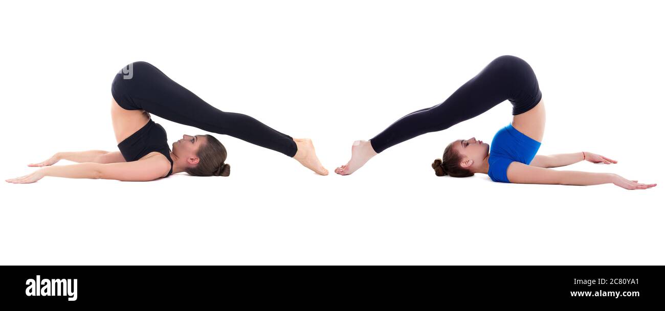 two beautiful sporty women doing stretching exercise isolated on white background Stock Photo