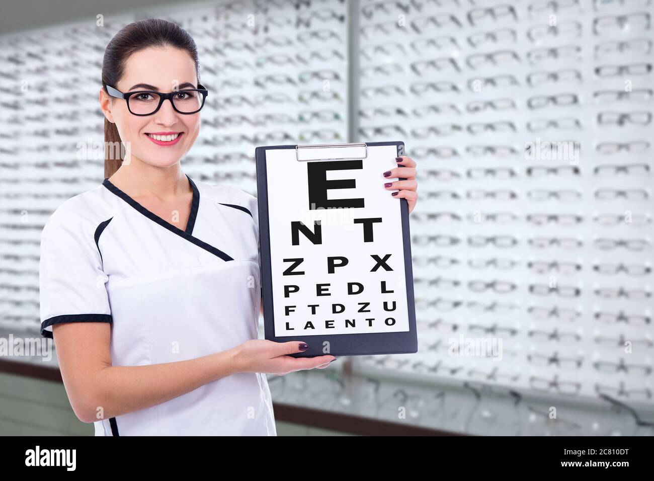 young woman optometrist or consultant holding clipboard with eyevision
