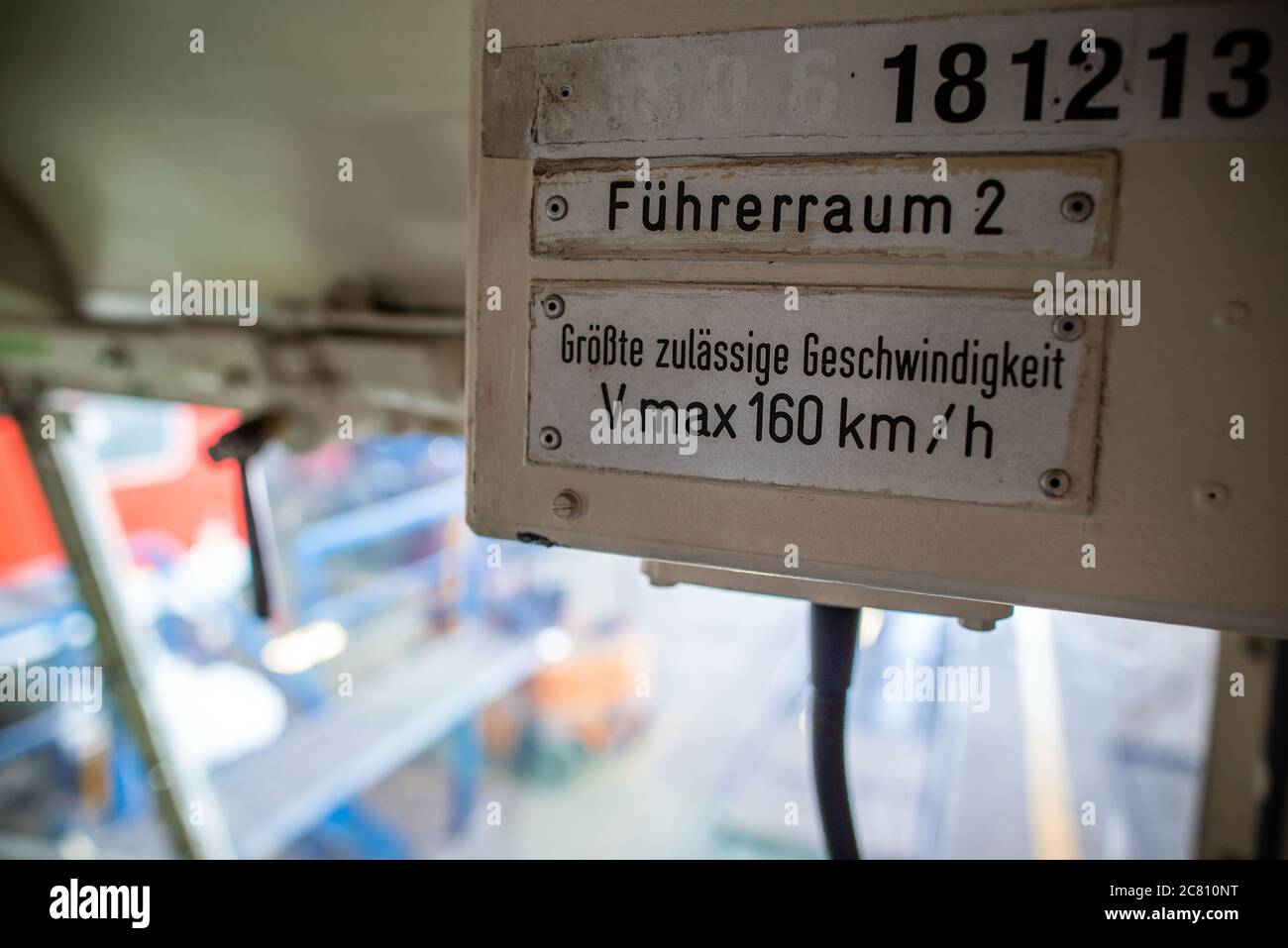 16 July 2020, Mecklenburg-Western Pomerania, Mukran: On the driver's cab of the class 181 electric locomotive built in 1972 in the repair workshop of Baltic Port Services GmbH (BPS) you can see the sign for maximum speed. Several of the locomotives built from a small series at Krupp in Essen and AEG in Berlin - today, eight of the once 29 of these electric locomotives still exist - are being repaired for the company Schlünß Eisenbahn Logistik (SEL) near Neumünster in Schleswig-Holstein. In the workshop opened by the Deutsche Reichsbahn in 1986, rail vehicles coming from the railway ferry were Stock Photo