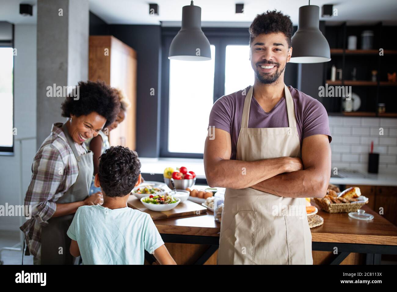 Happy family preparing together food in the kitchen Stock Photo