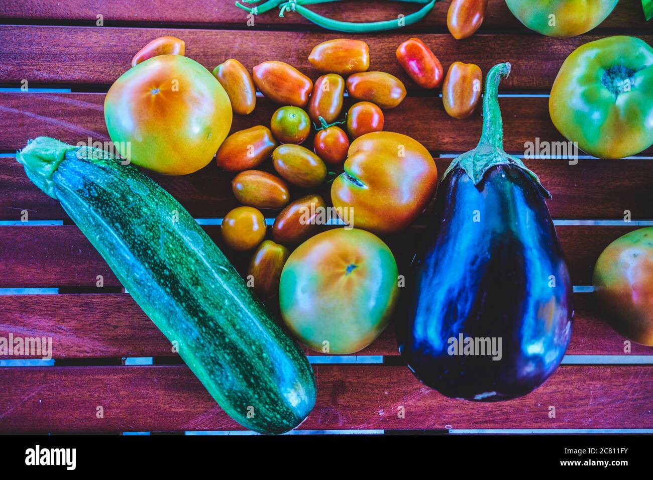 closeup of freshly picked vegetables, aubergines, tomatoes, zucchini Stock Photo