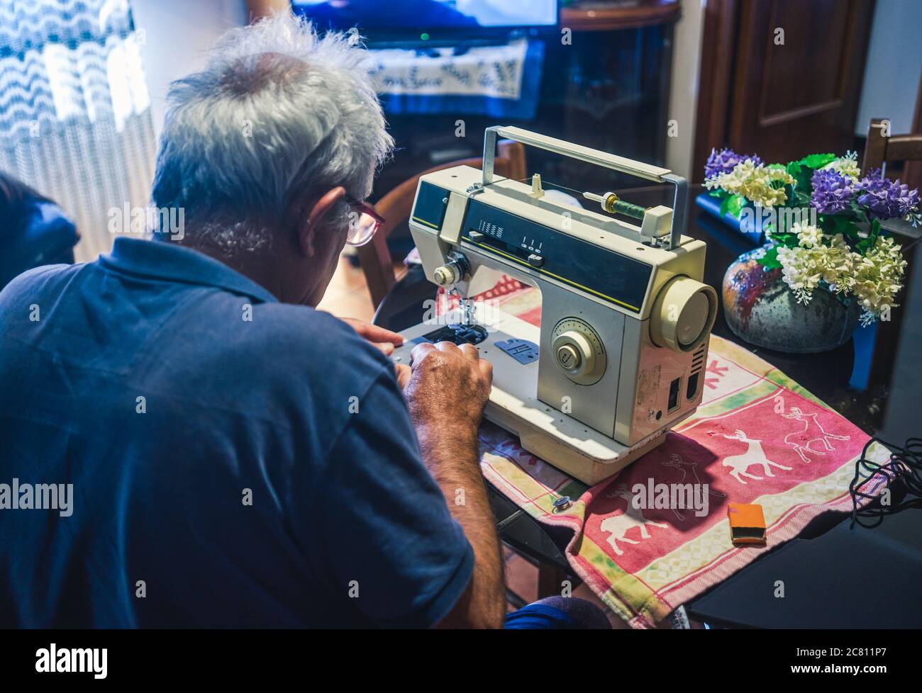 elderly man using a sewing machine Stock Photo Alamy
