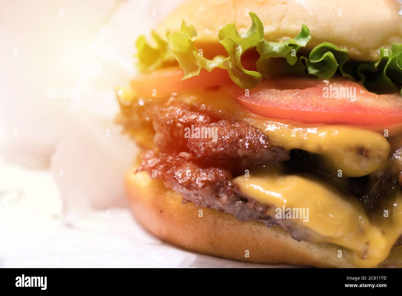 Double cheeseburger with tomato lettuce and onion, Cheese Fries and Milkshake. Stock Photo