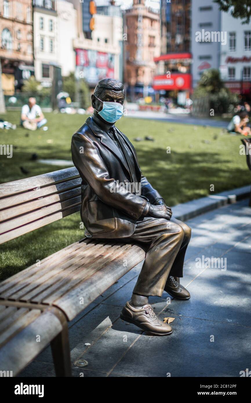 Alone as usual, Mr. Bean wears a mask in Leicester Square during the London lockdown following the coronavirus pandemic. Stock Photo