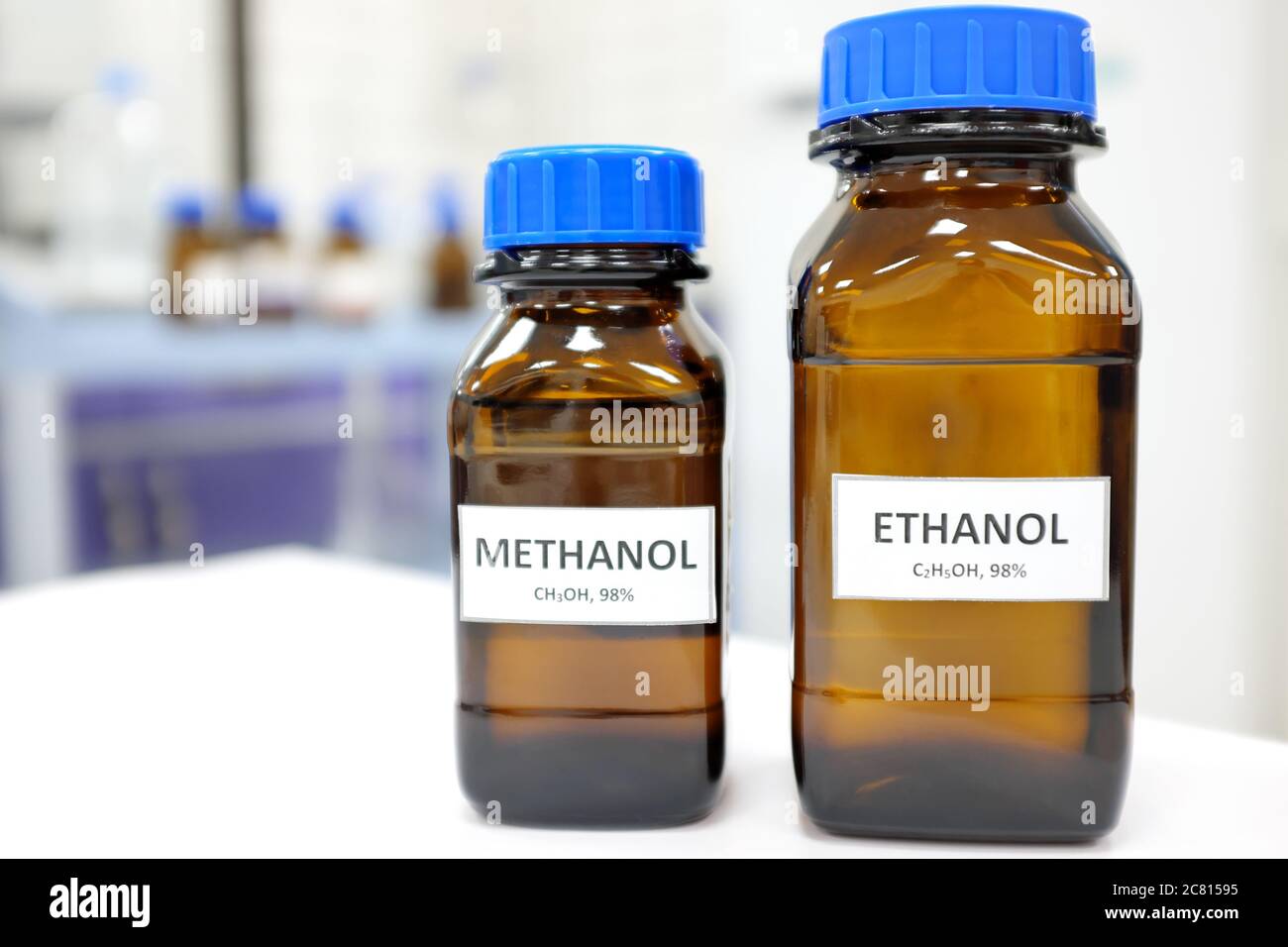 Selective focus of ethanol and methanol brown amber glass bottle inside a laboratory. Blurred background with copy space. Stock Photo