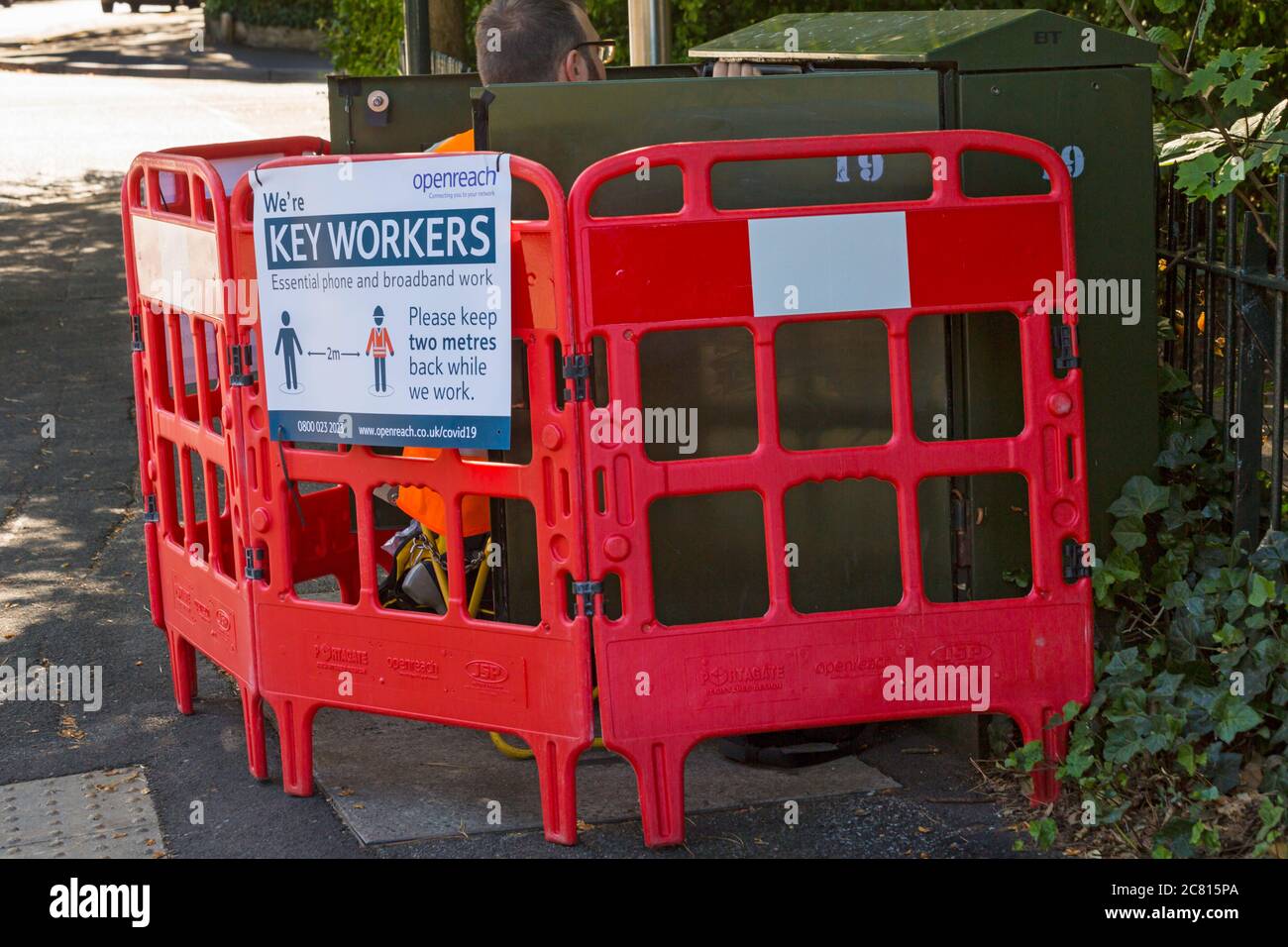 Openreach we're keyworkers essential phone and broadband work please keep two metres back while we work sign at Bournemouth, Dorset UK in July Stock Photo