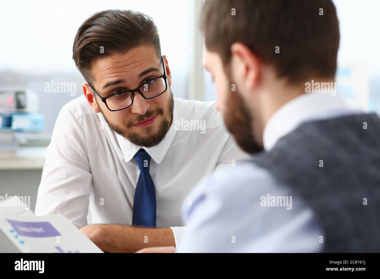 Two managers discussing work matters in office Stock Photo