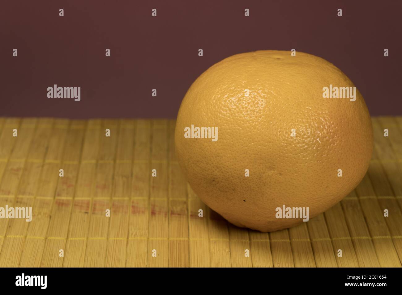 One grapefruit on a bamboo background Stock Photo