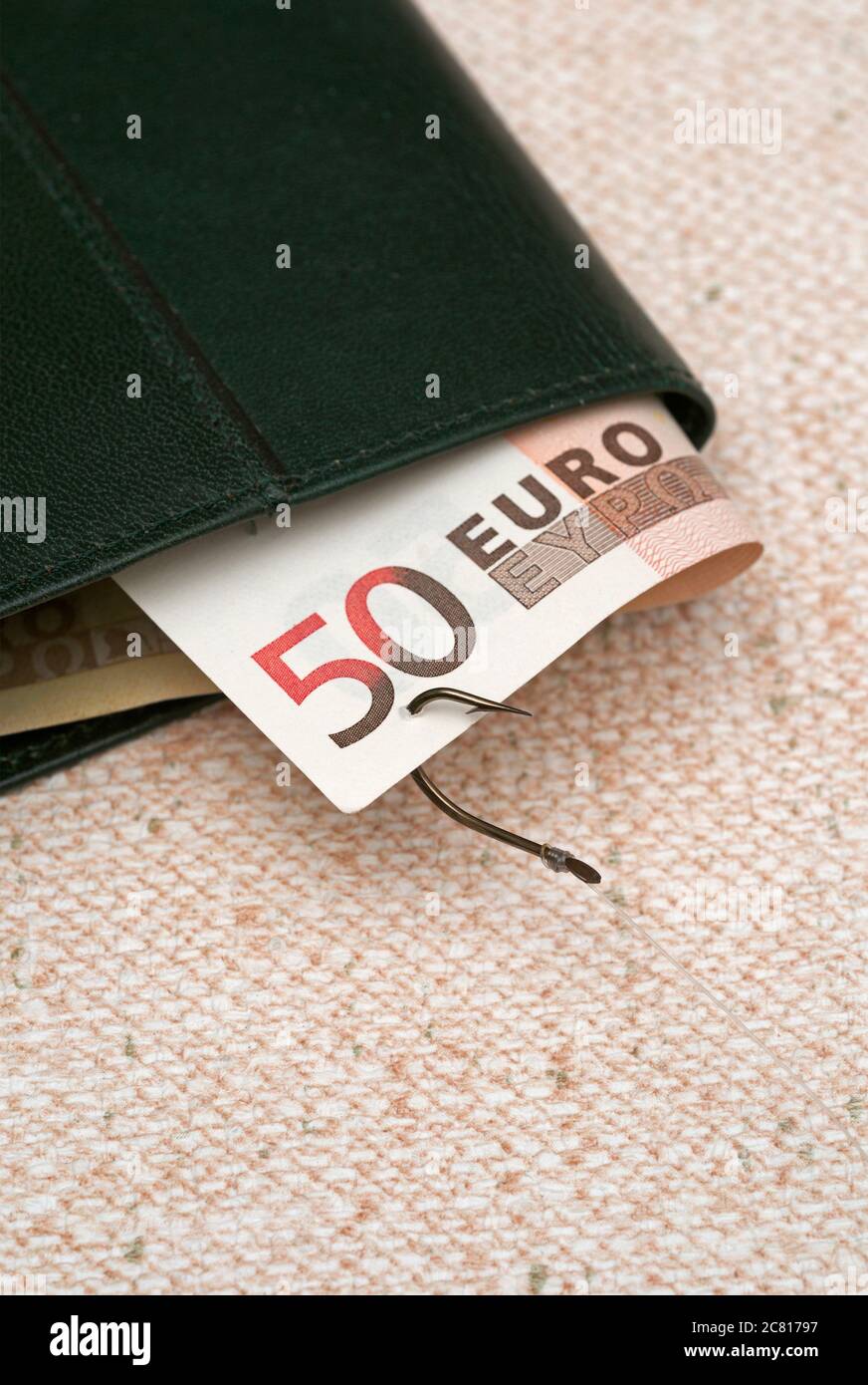 fishing hook snatching euro  banknote out of a wallet Stock Photo