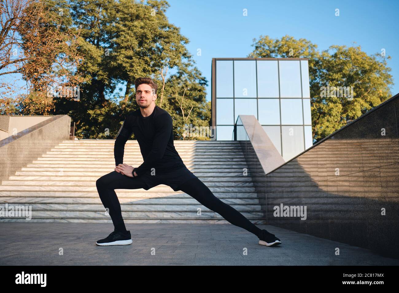 Young sporty man stretching hi-res stock photography and images - Alamy