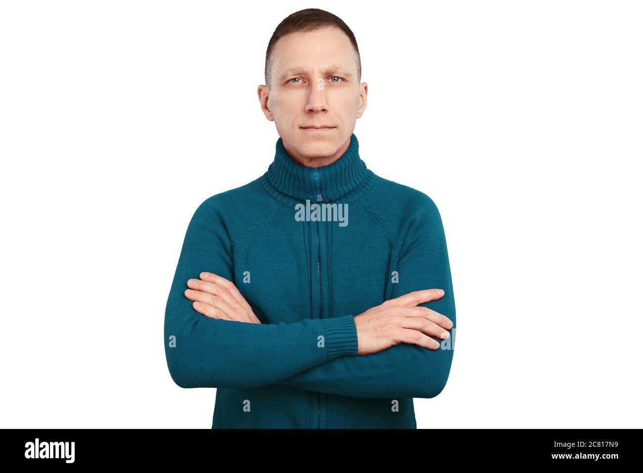 Serious average age man with crossed arms in blue sweater isolated on white background. Stock Photo