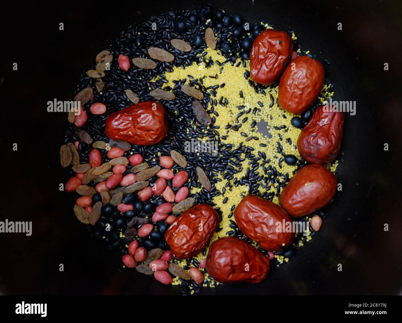 top view of colorful porridge ingredients in black background. Mixed cereal and millet. Natural healthy eating concept Stock Photo