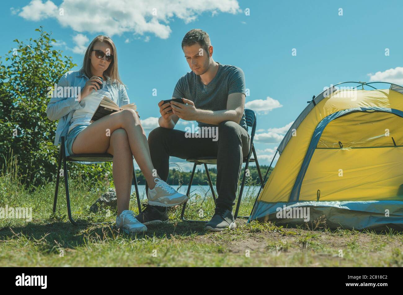 Man woman sitting near tent hi-res stock photography and images - Alamy