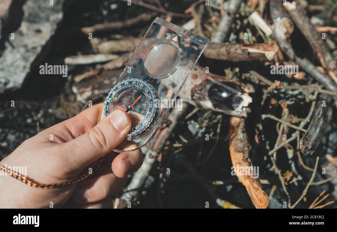 Man uses a magnifying glass to burn a bonfire Stock Photo Alamy