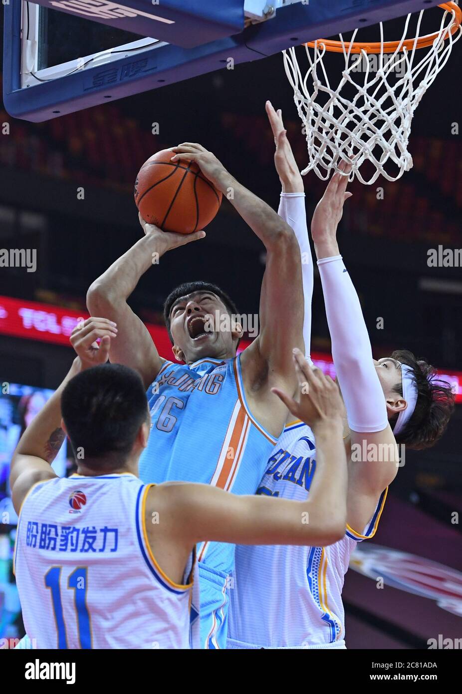 Qingdao, China's Shandong Province. 20th July, 2020. Lutubula (L, top) of  Xinjiang Flying Tigers goes up for a basket during a match between Fujian  Sturgeons and Xinjiang Flying Tigers at the 2019-2020