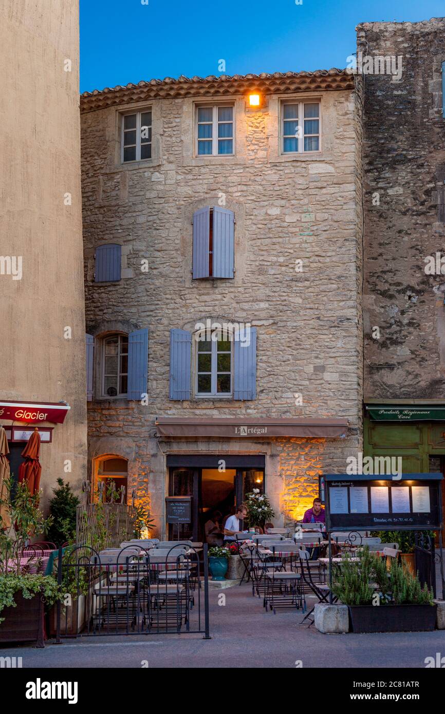 Twilight over an outdoor cafe in Gordes, Provence, France Stock Photo