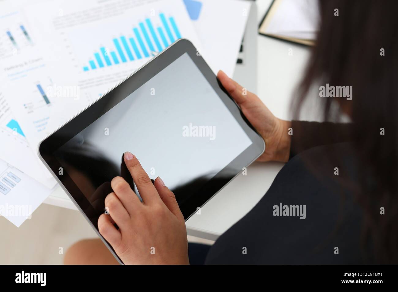 Businesswoman using touchpad while working in office Stock Photo