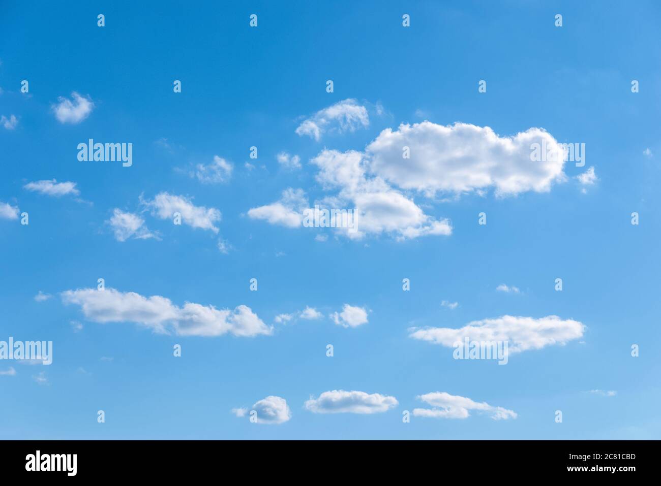 few random white clouds in blue sky, partly cloudiness Stock Photo