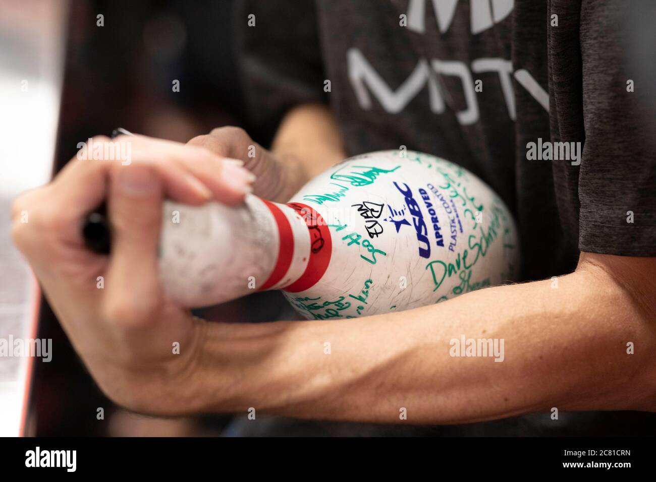 Austin, TX USA July 17, 2020: A bowling pin is passed around for patrons to sign at the last bowling night at Dart Bowl as the lanes, open for 64 years, close due to economic struggles and the COVID-19 pandemic.  Credit: Bob Daemmrich/Alamy Live News Stock Photo