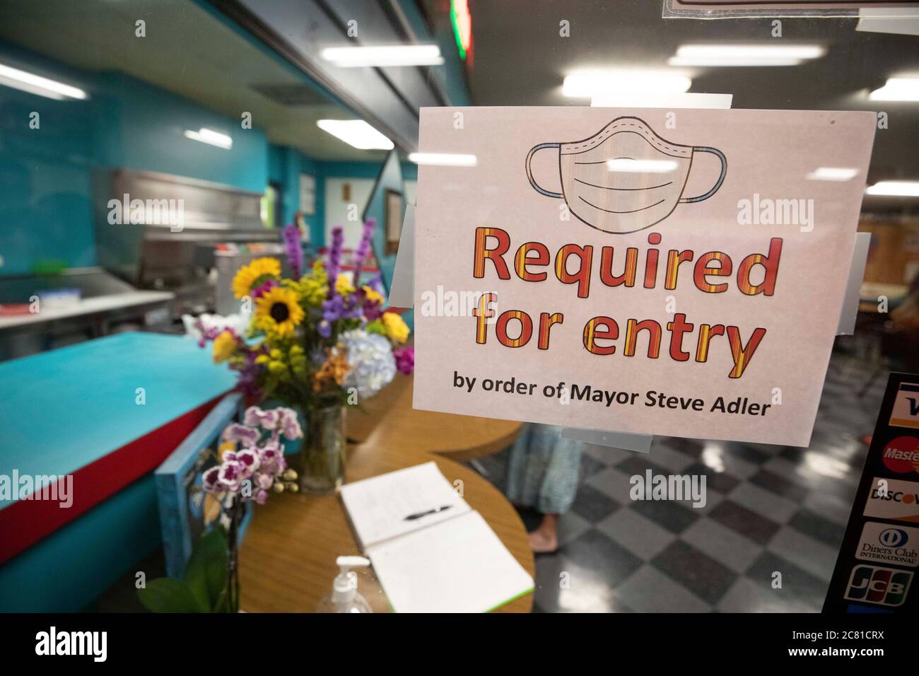 Austin, TX USA July 17, 2020: A mask-required sign greets customers  at the entrance to the cafe at Dart Bowl on the last  of business. The locally owned small business, open for 64 years, closed due to economic struggles and the COVID-19 pandemic. Credit: Bob Daemmrich/Alamy Live News Stock Photo