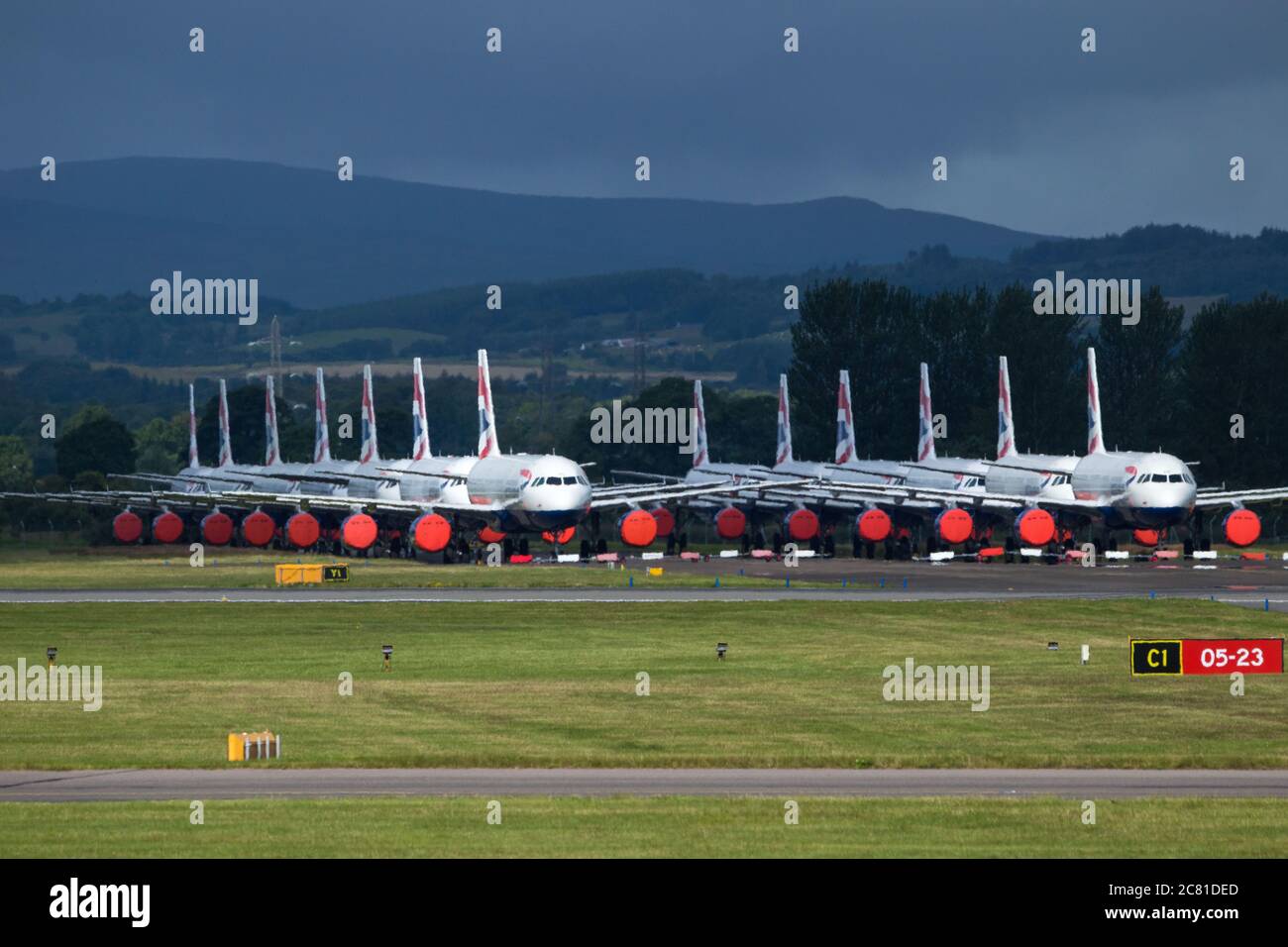 Glasgow, Scotland, UK. 20 July 2020 Pictured: Grounded BA jets at Glasgow Airport. Since March, all flights in and out of the UK were grounded the UK went into lockdown following a sharp rise in coronavirus cases in Europe. On July 6, many flights resumed, although the Foreign Commonwealth Office advised travel only where absolutely necessary. According to new terms currently being drafted between the British Airline Pilots' Association (BALPA) and British Airways, captains and first officers placed in the pool will remain on half-pay until they are needed. Credit: Colin Fisher/Alamy Live News Stock Photo