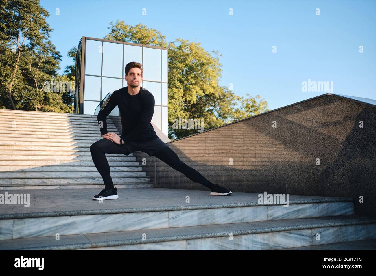 Young sporty man stretching hi-res stock photography and images - Alamy