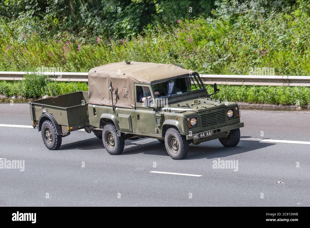 1999 green Army style SWB 2495 diesel Land Rover ; 1990s Vehicular traffic moving vehicles, cars driving vehicle on UK roads, motors, motoring on the M6 motorway highway network. Stock Photo