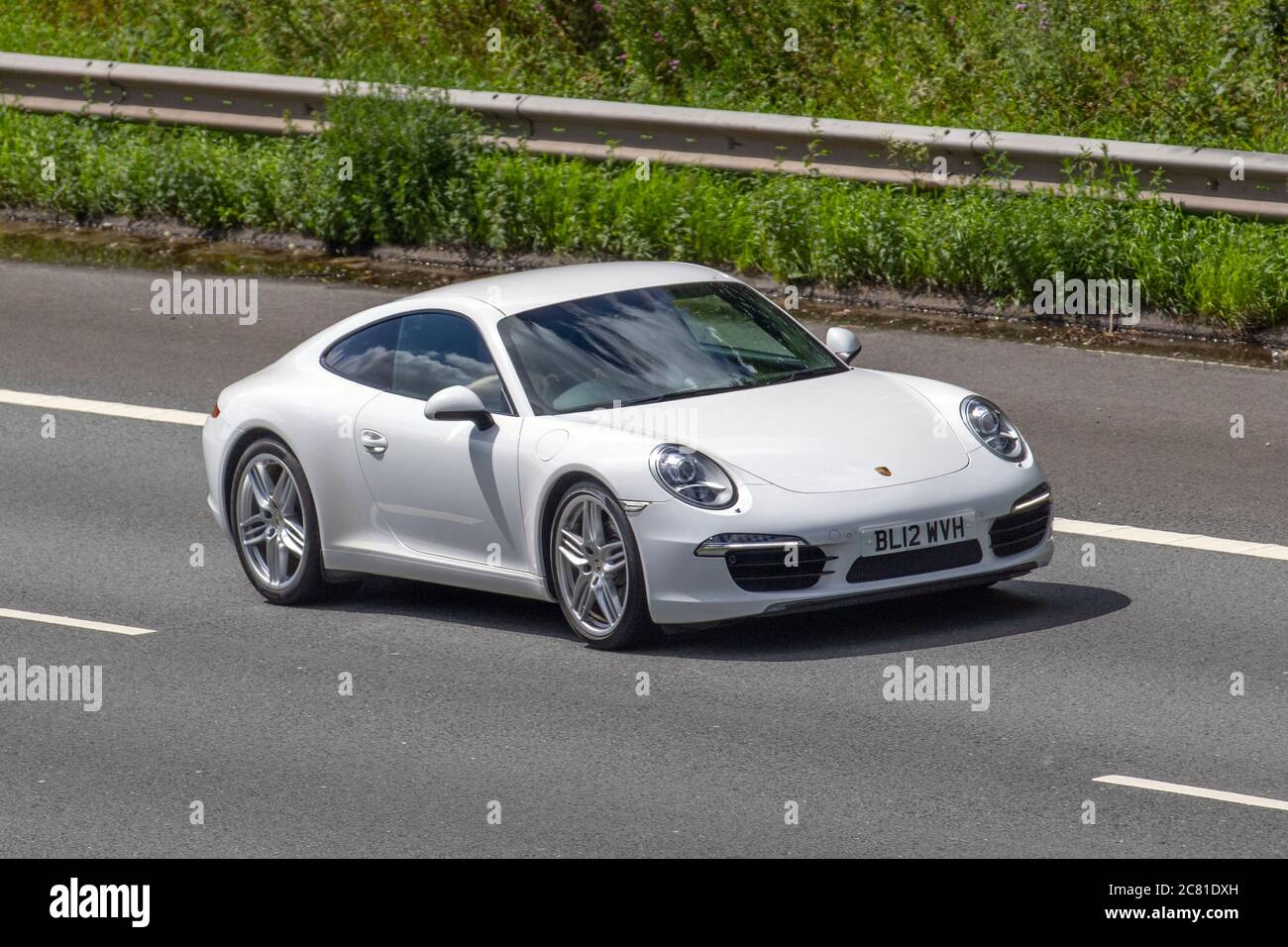 2012 Porsche 911 Carrera S-A; Vehicular traffic moving vehicles, cars driving vehicle on UK roads, motors, motoring on the M6 motorway highway network. Stock Photo