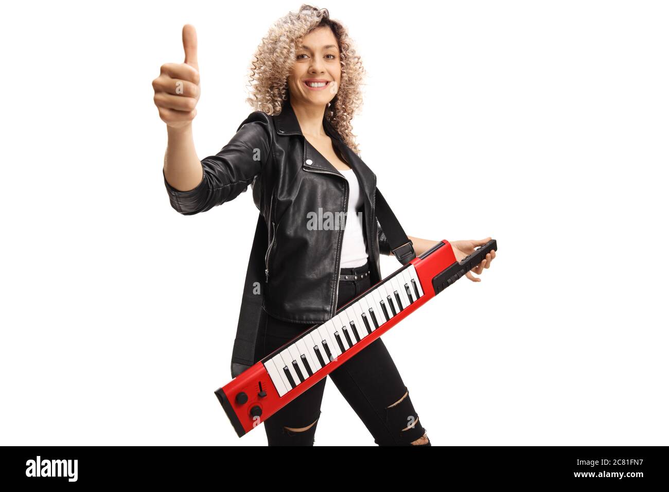 Woman with a red keytar synthesizer showing a thumb up sign isolated on white background Stock Photo