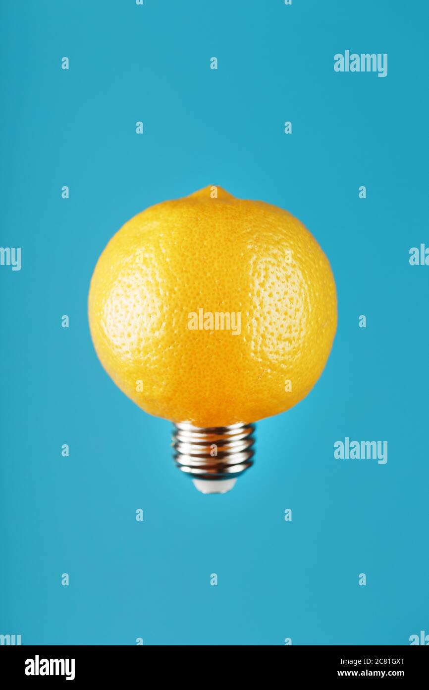 Light bulb lemon in flight on a blue background. The conceptual idea