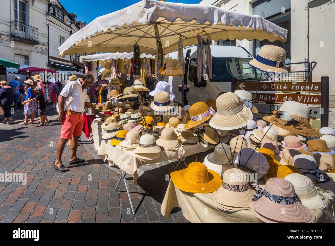 Man looking at straw hats in French open-air market - Loches, Indre-et-Loire, France. Stock Photo