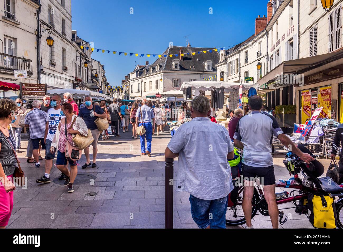 Crowded market square on market day with many people wearing face-masks - Loches, Indre-et-Loire, France. Stock Photo