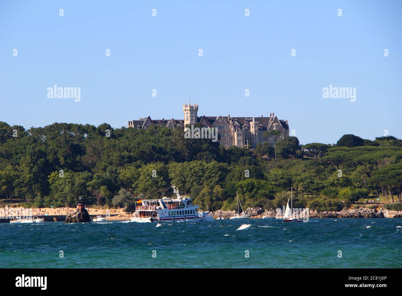Pleasure boat passing in front of the Magdalena Palace Santander Cantabria Spain Stock Photo