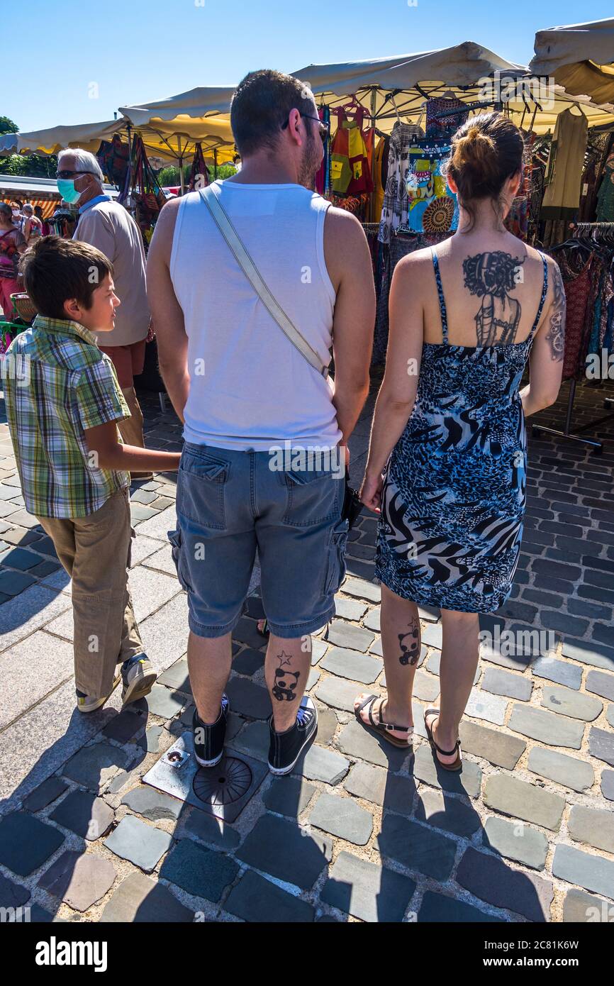 Family with matching tattoos on legs - France. Stock Photo