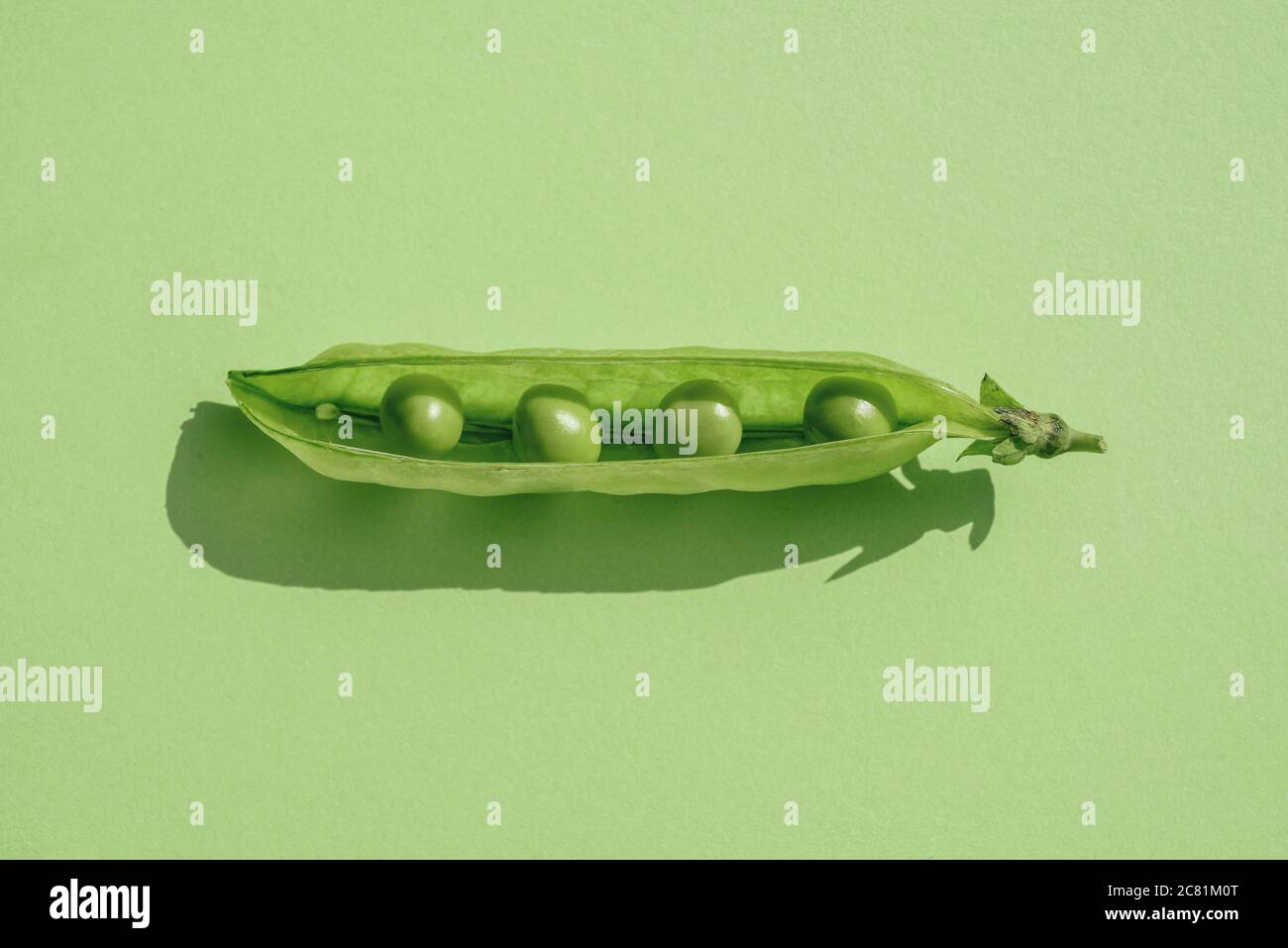 Social distance concept, Pod of green peas with seeds at great distance between Stock Photo